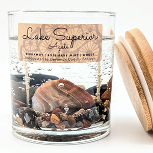 Candle jar with a Lake Superior Agate and wooden lid on a white background